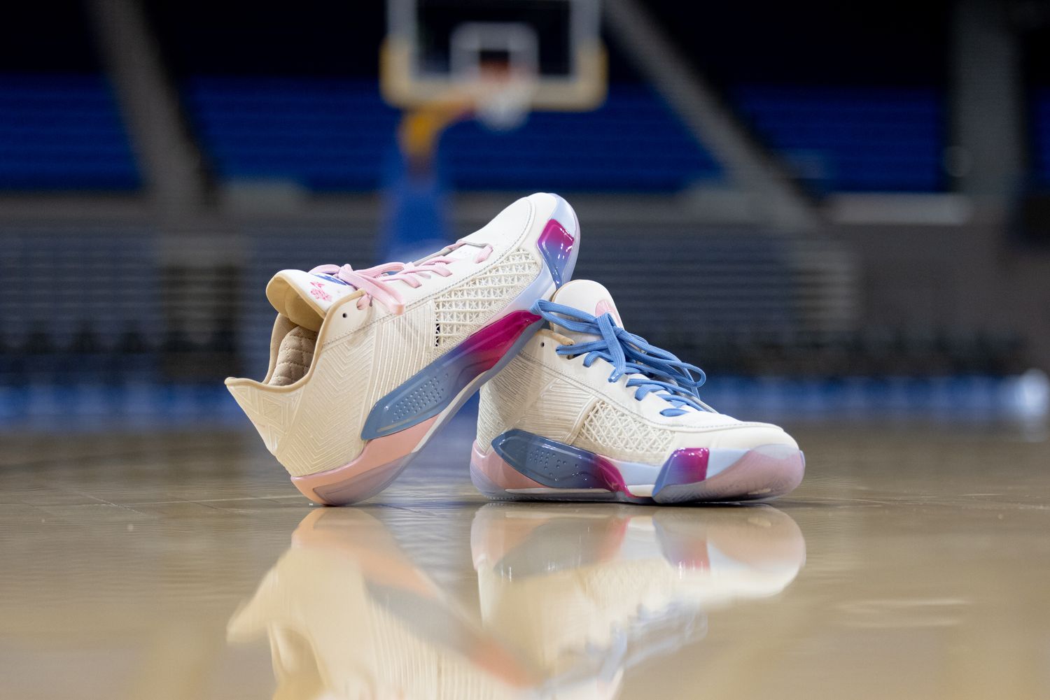 White and pink Air Jordan sneakers on the UCLA basketball court.